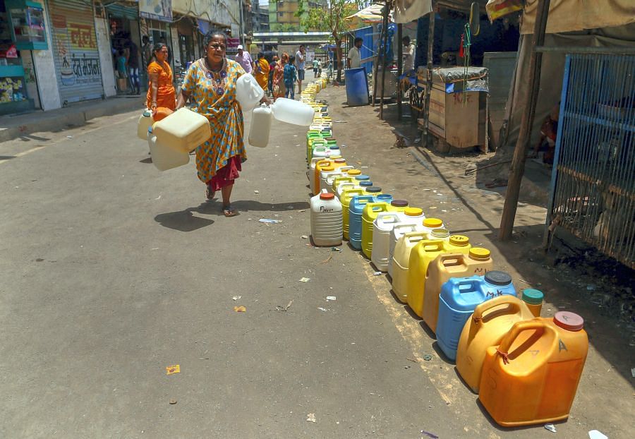 Cans lined up to collect water in Thane. Temperatures have soared in Maharashtra. Credit: PTI Photo