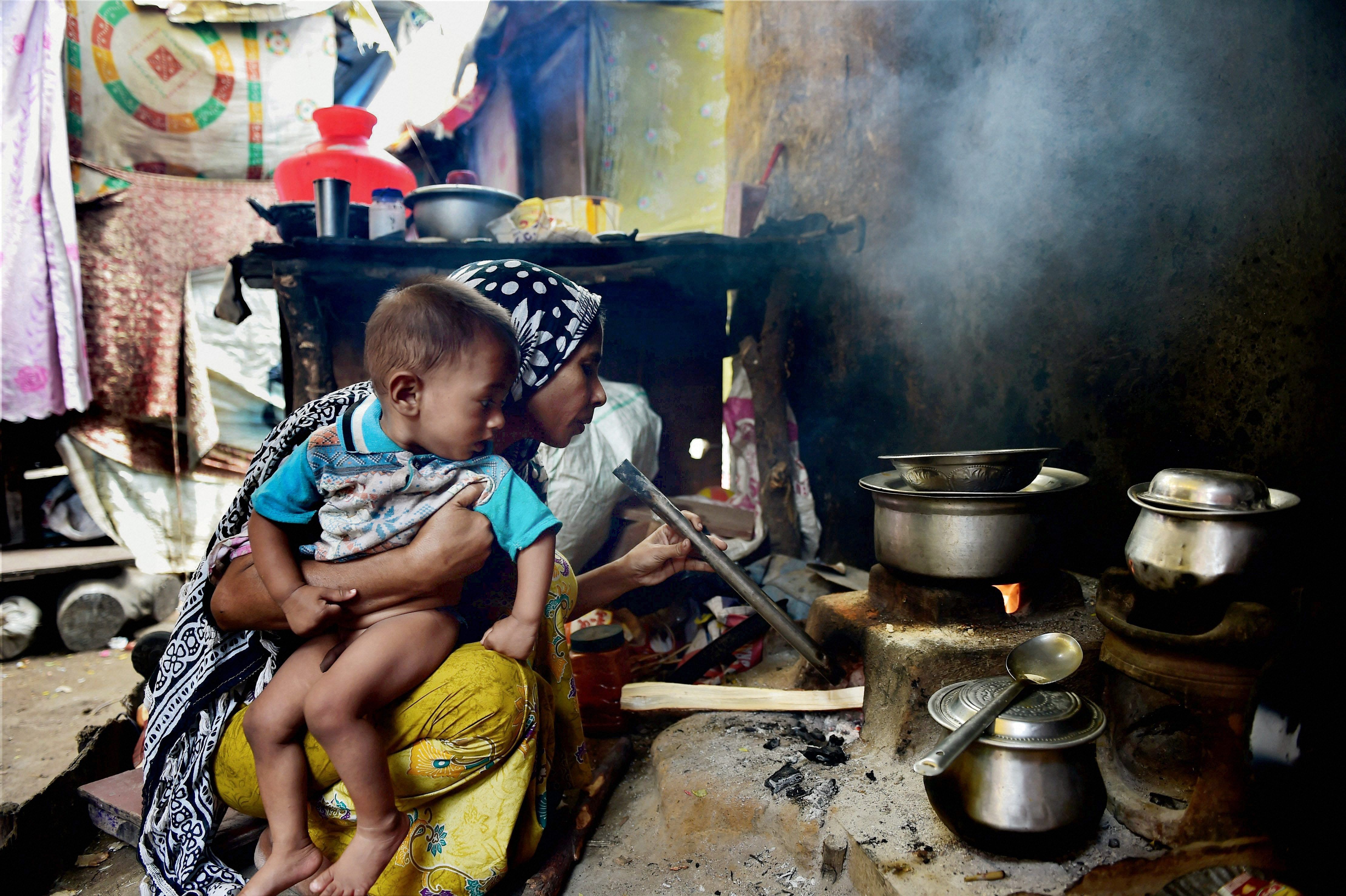 A Rohingya Muslim refugee woman of Myanmar cooking food on a chullah at a camp at Kelambakkam in Chennai. (PTI file photo)