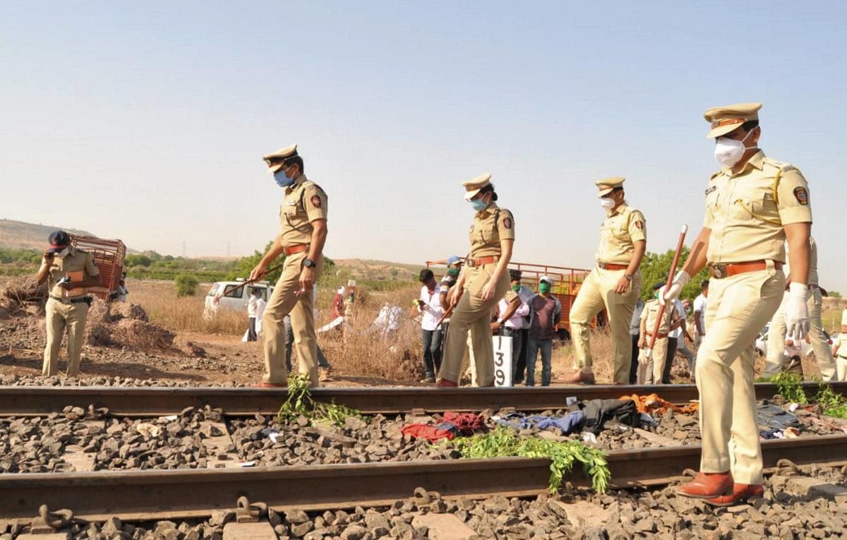  Police personnel inspect the spot after a goods train ran over a group of migrant workers while they were sleeping on the tracks, in Aurangabad. PTI