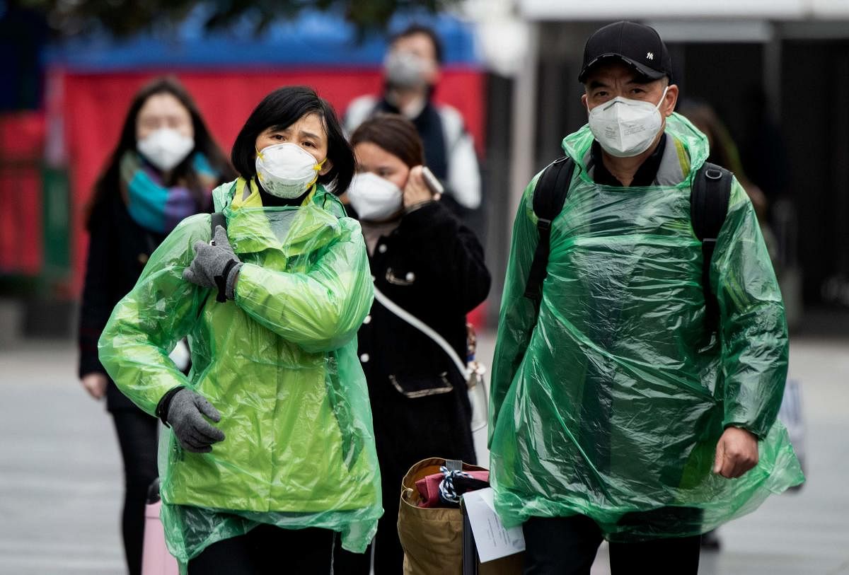 People wearing protective face masks arrive at a railway station in Shanghai on February 10, 2020. Credit: AFP Photo