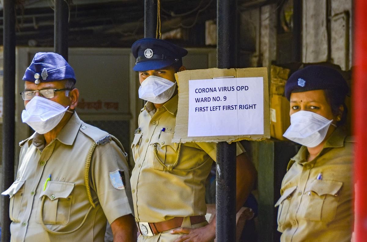 Security personnel wear masks to mitigate the spread of coronavirus, outside a special isolation ward at Kasturba Hospital, in Mumbai, Sunday, March 15, 2020. (PTI Photo)