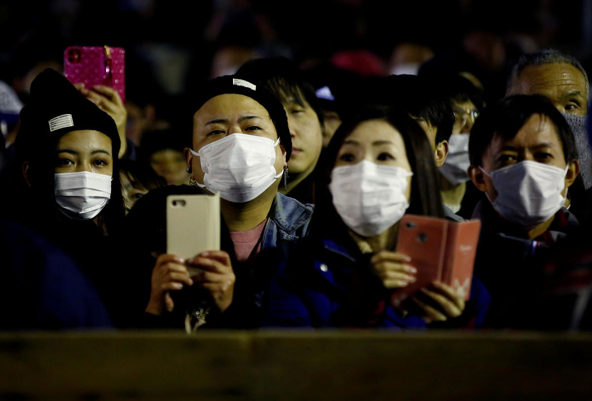 People in protective masks, during the outbreak of the novel coronavirus, watch a naked festival at Saidaiji Temple in Okayama, Okayama Prefecture Japan February 15, 2020. Credoy: Reuters Photo