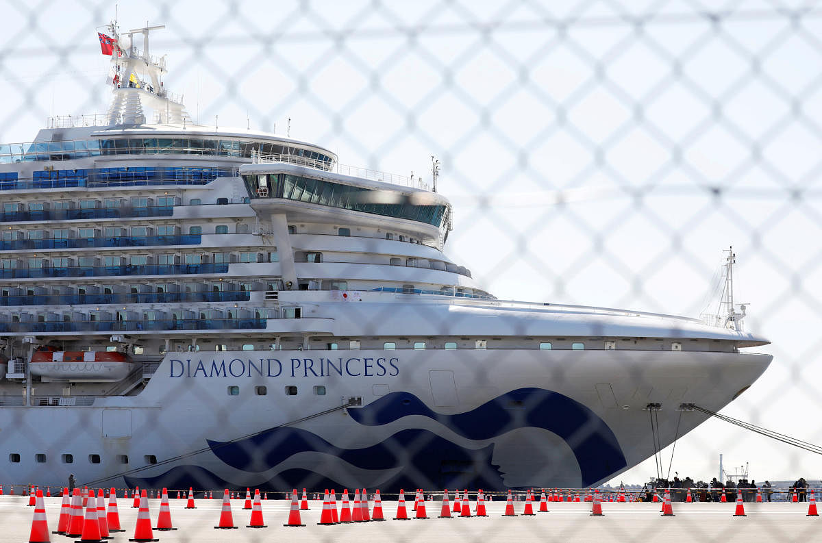 The Diamond Princess, where many passengers have tested positive for coronavirus, is seen through steel fence at Daikoku Pier Cruise Terminal in Yokohama. Credit: Reuters Photo