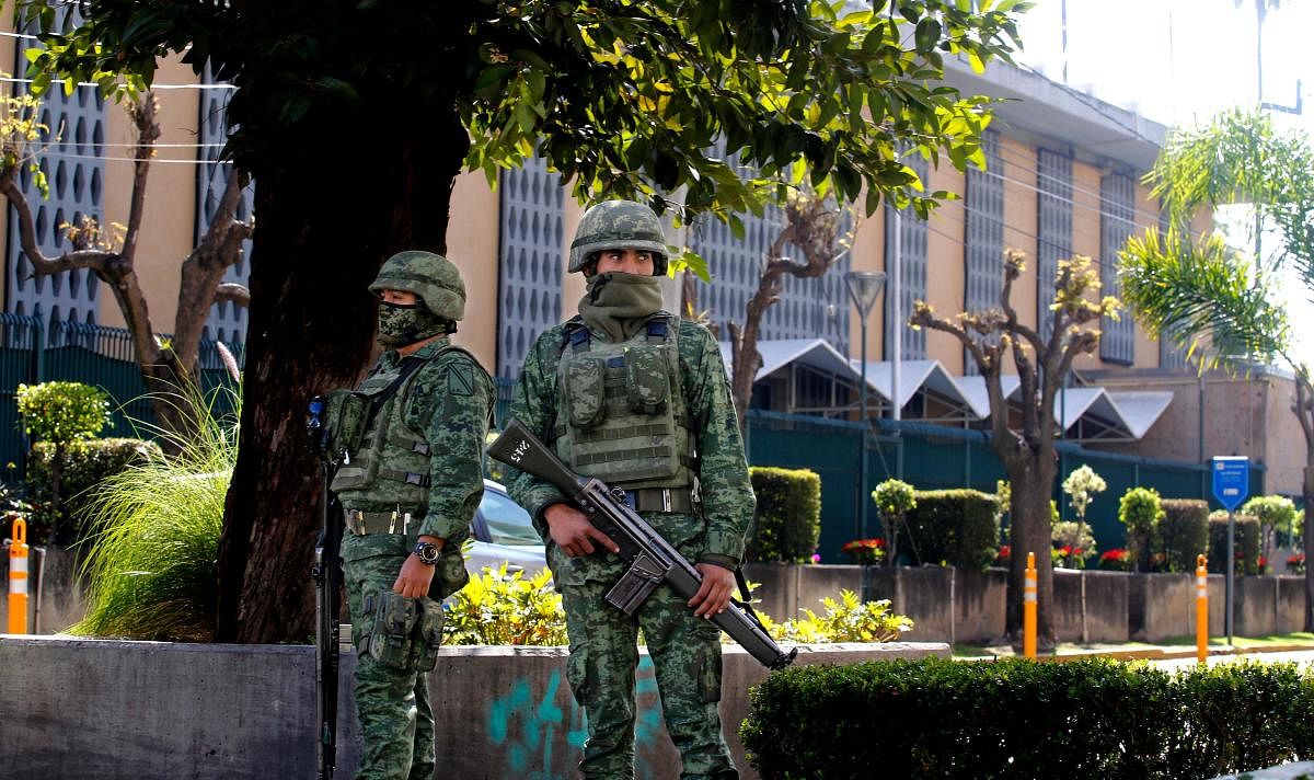 Members of the Mexican Army stand guard outside the US Consulate in Guadalajara, Mexico on December 01, 2018, after an attack with an explosive device left a wall damaged but nobody injured. (AFP Photo)