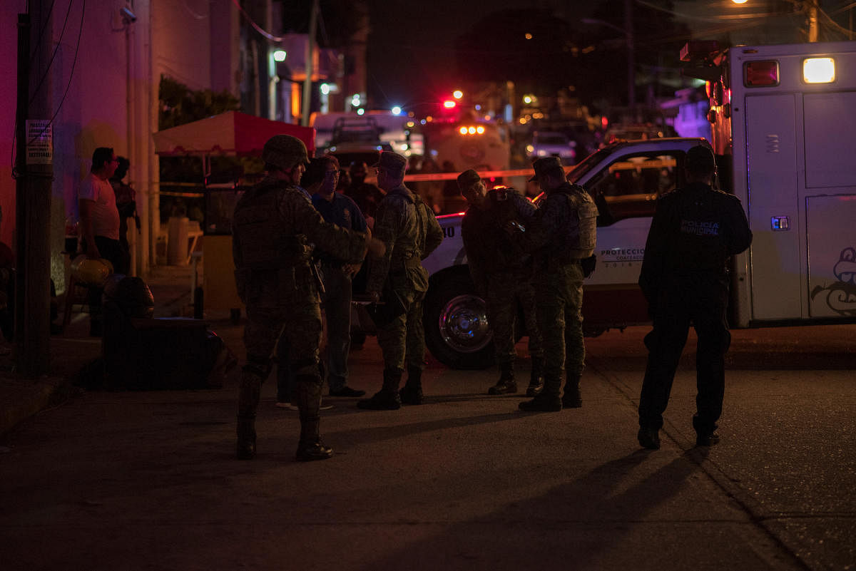 Soldiers gather near a crime scene following a deadly attack at a bar by unknown assailants in Coatzacoalcos. Reuters photo