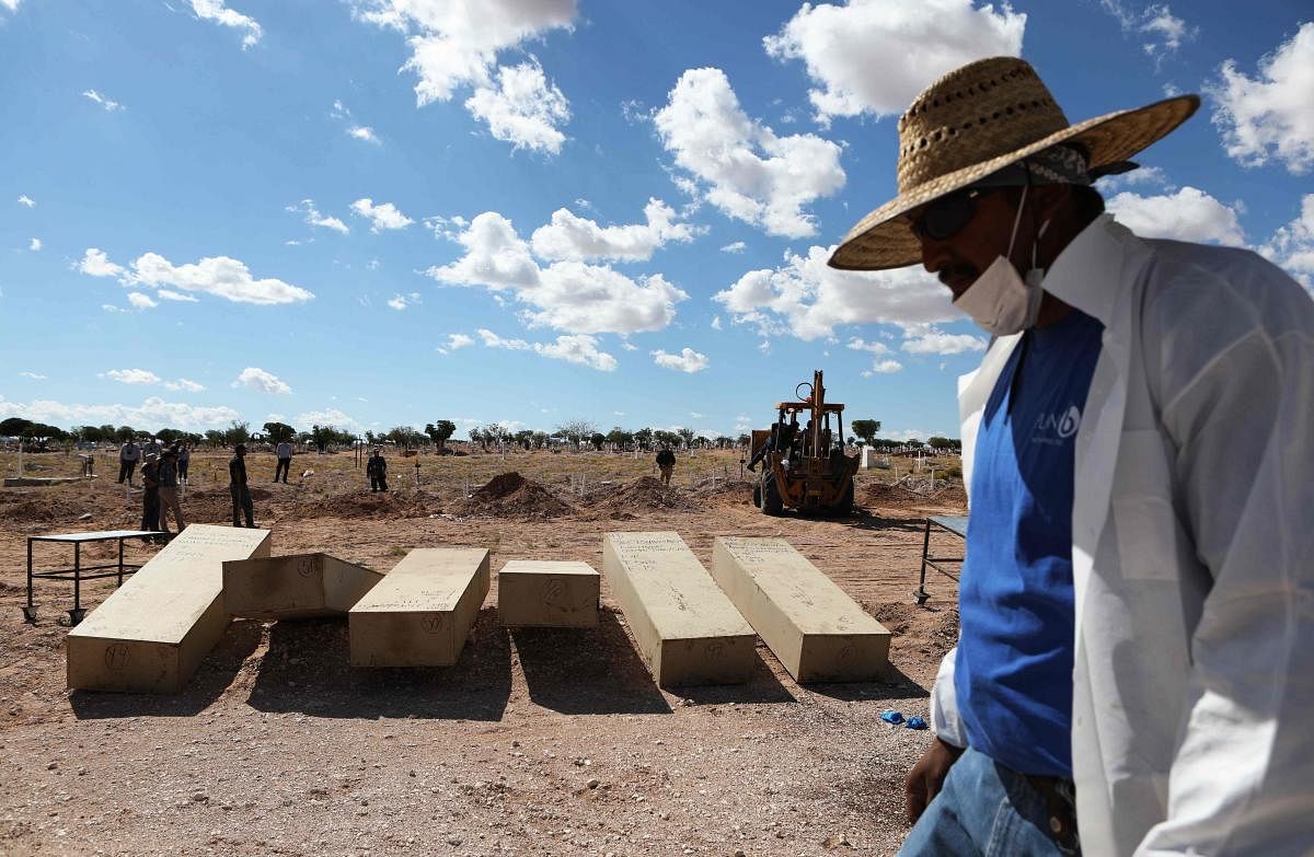 A judicial worker walks past coffins with unclaimed corpses (AFP Photo)