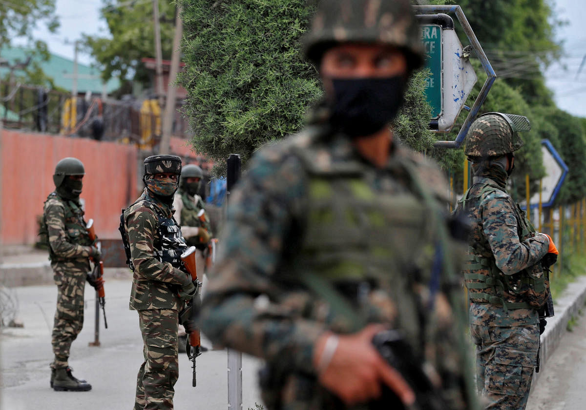 India's Central Reserve Police Force personnel stand guard alongside a road in Srinagar (Reuters Photo)