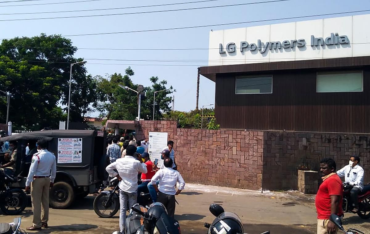 Policemen stand guard as people gather in front of a LG Polymers plant following a gas leak incident in Visakhapatnam on May 7, 2020. Credit: AFP Photo