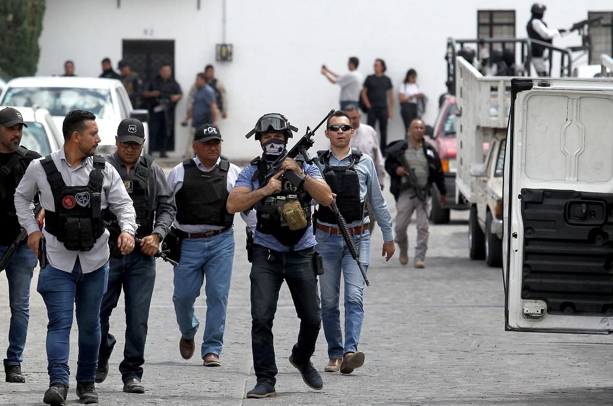 Police members patrol during an operation after two ministerial agents, 6 kidnapped people and a civilian lost their lives during a confrontation in the La Huertas neighborhood in Tlaquepaque, Mexico. AFP
