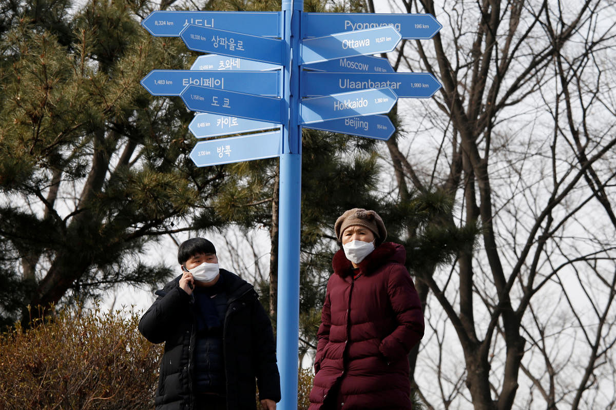 People wear masks to prevent contracting a new coronavirus near "N Seoul Tower" in Seoul. Credit: Reuters Photo
