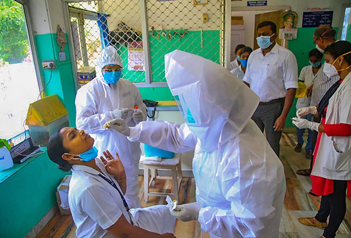 Staff members at a sealed hospital give samples for COVID-19 tests after a relative of a patient was detected positive for the new virus, at Krishnan Kovil village of Nagercoil in Kanyakumari district, Thursday, May 7, 2020. (PTI Photo) 