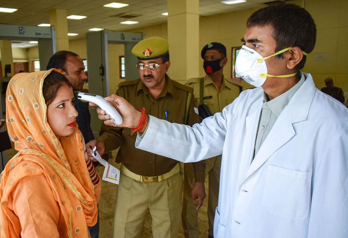 Thermal screening of visitors being conducted in the wake of deadly coronavirus, at the entrance of Allahabad High Court, in Prayagraj, Monday, March 16, 2020. (PTI Photo)