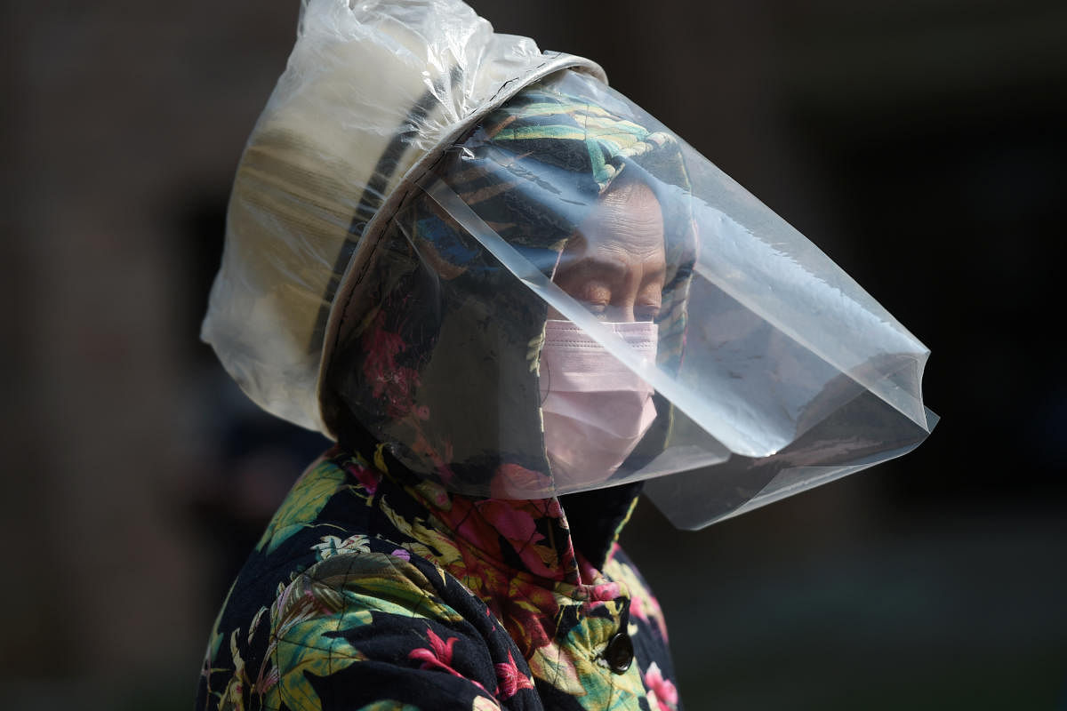 A resident wears a makeshift protective face shield at a residential compound in Wuhan. Credit: Reuters Photo