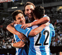 super finish: Argentinas Gonzalo Higuain (centre) is embraced by Lionel Messi (left) and Ezaquiel Lavezzi after scoring against Venezuela during their World Cup qualifying match on Friday at Buenos Aires. AFP
