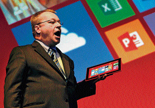 Nokia CEO Stephen Elop holds a Nokia Lumia 2520 on stage in Abu Dhabi on Tuesday. AFP