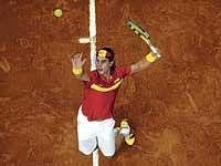 Spains Rafael Nadal serves to Czech Republics Tomas Berdych in the Davis Cup final in Barcelona on Friday. AFP