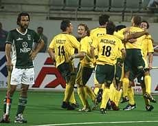 South African players celebrate after scoring a goal against Pakistan as Pakistani player Shakeel Abbasi (left) watches during the World Cup hockey match in New Delhi on Saturday. AP