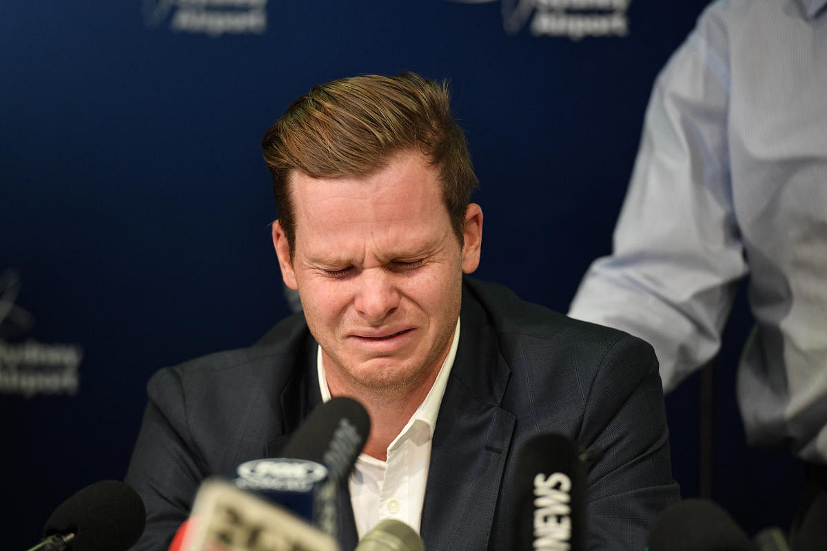 Disgraced Australian Cricket Captain Steve Smith reacts at Sydney International Airport. REUTERS.