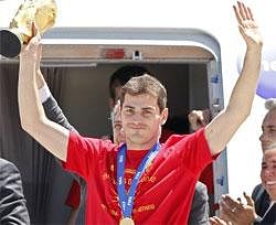 Spain's captain Iker Casillas raises the World Cup trophy as he leaves the aircraft that brought the Spanish team back from South Africa, at Madrid's Barajas airport, Monday. AP