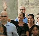 Holiday headache: Michelle Obama waves during a visit to Ronda in Spain on Saturday. AP