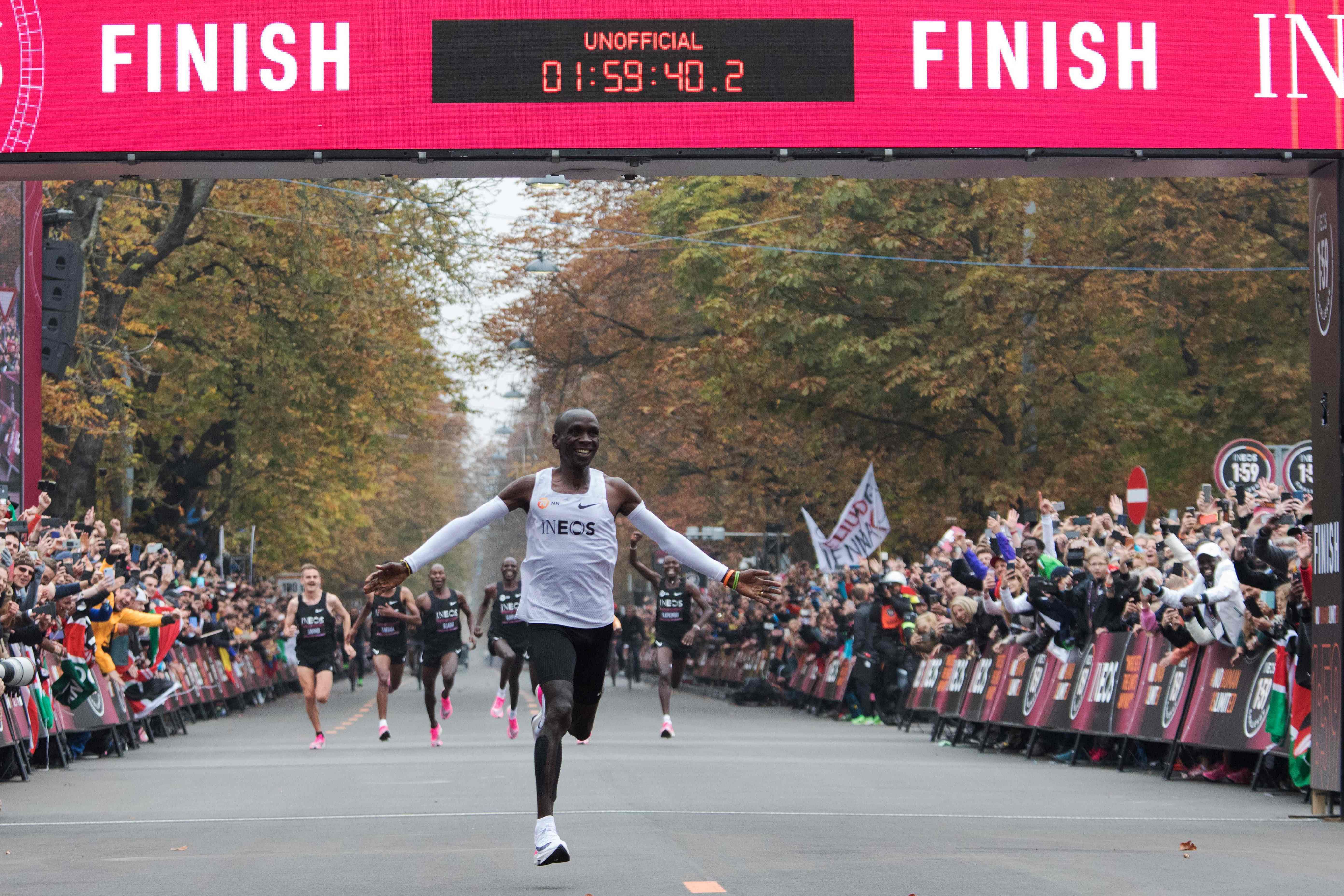 In this file photo taken on October 12, 2019 Kenya's Eliud Kipchoge (white jersey) celebrates as he crosses the finish line at the end of his attempt to bust the mythical two-hour barrier for the marathon. (AFP)
