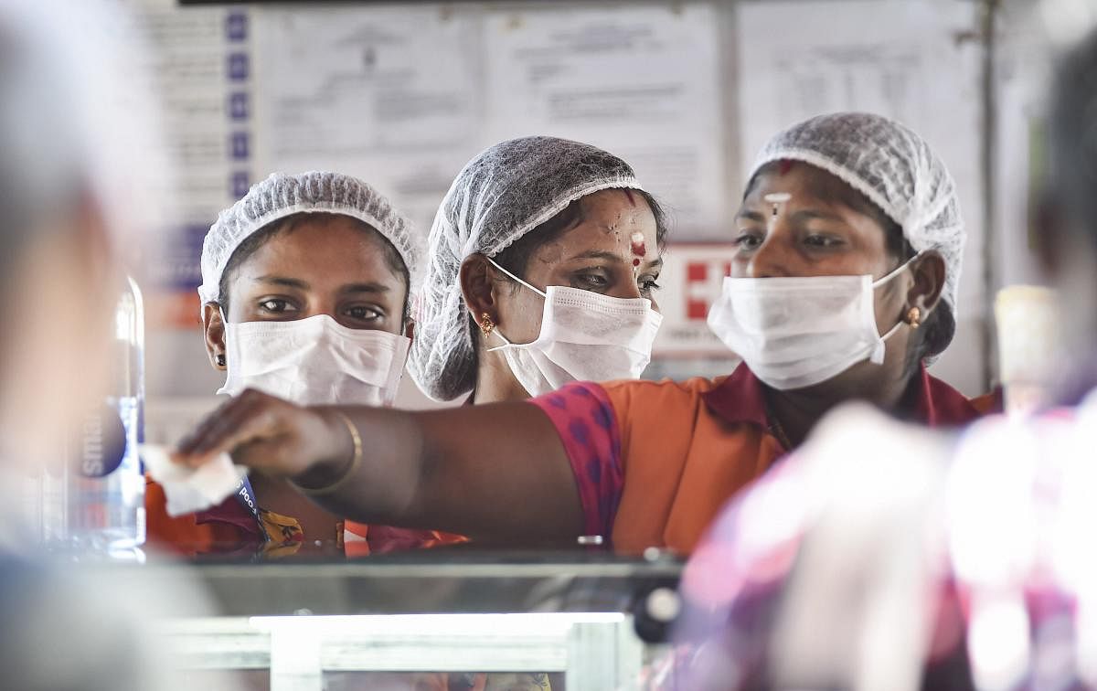 Workers wear masks to protect themselves in the wake of deadly coronavirus, at Chennai airport, Tuesday, March 17, 2020. (PTI Photo)