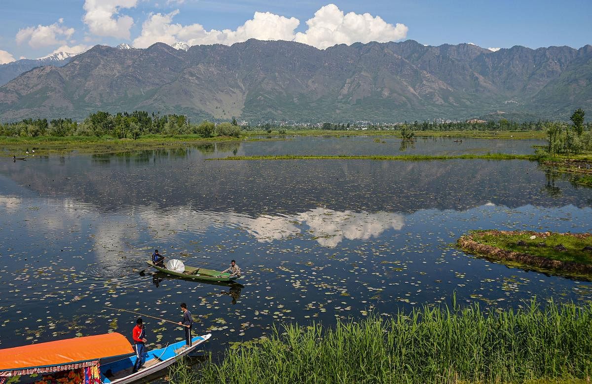 Young boys prepare to fish the during the ongoing nationwide COVID-19 lockdown, at Dal Lake in Srinagar. (PTI Photo)