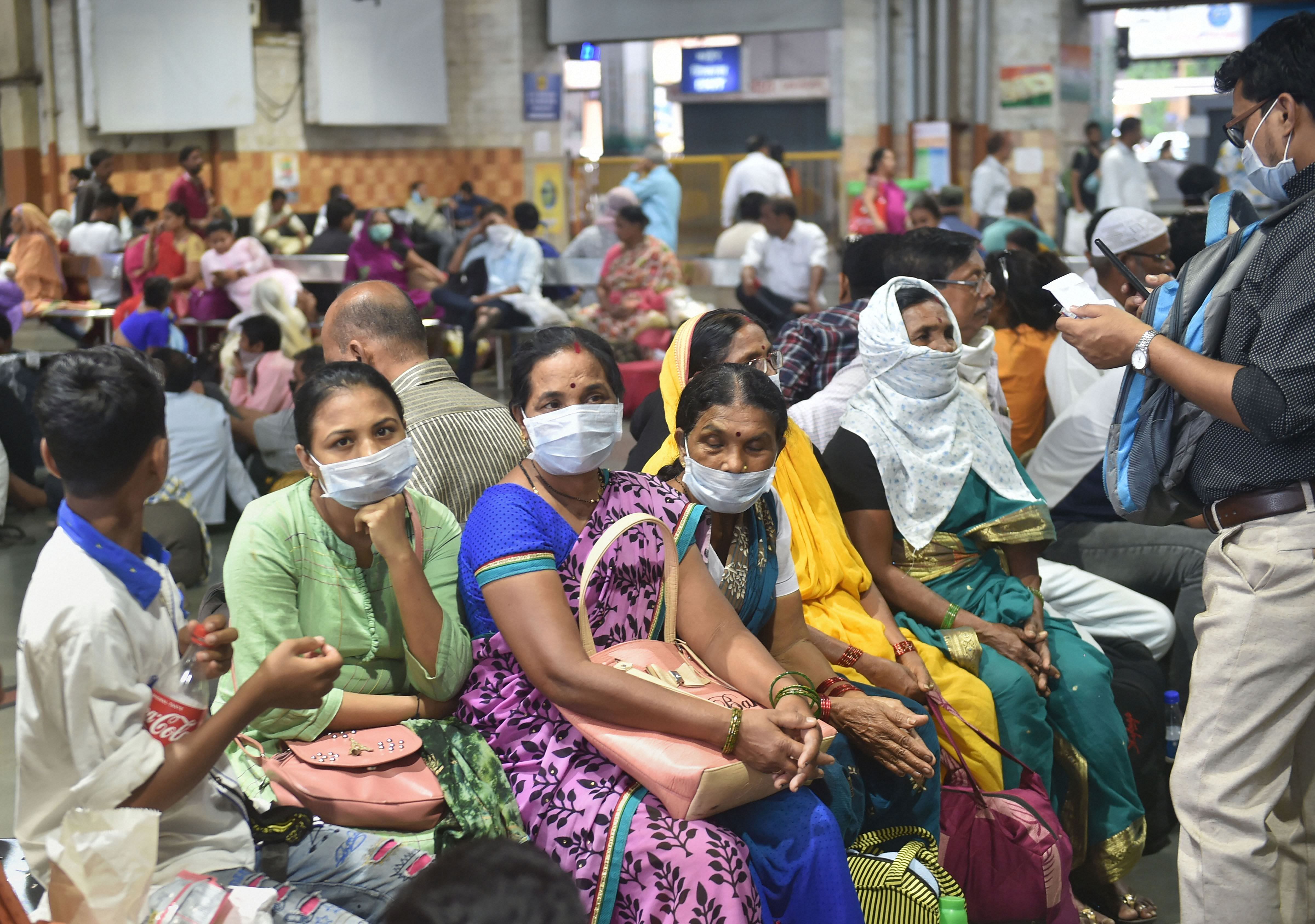 Passengers wear masks as a precautionary measure against the coronavirus, at Chhatrapati Shivaji Maharaj Terminus in Mumbai. (PTI Photo)