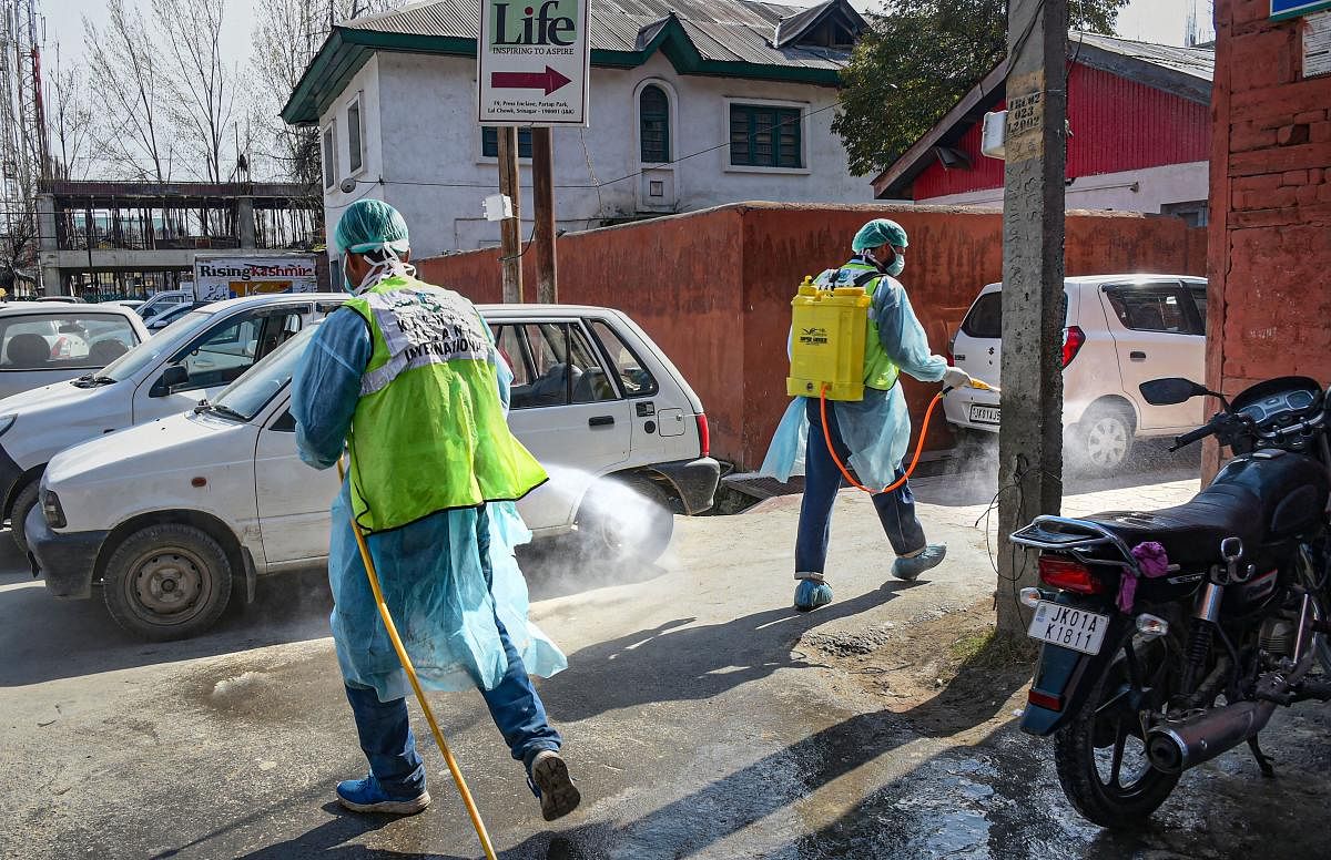 Volunteers spray disinfectant as a precautionary measure against coronavirus(COVID-19) in Srinagar (PTI Photo)