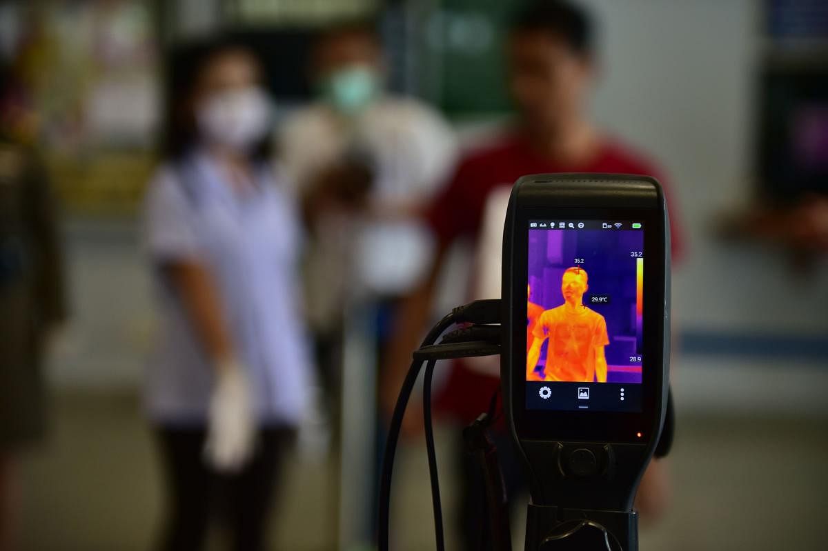 A thermal camera monitor shows the body temperatures of a man at the customs checkpoint in Sungai Kolok in southern Thailand's Narathiwat province on the Thailand-Malaysia border on March 15, 2020. Credit: AFP Photo