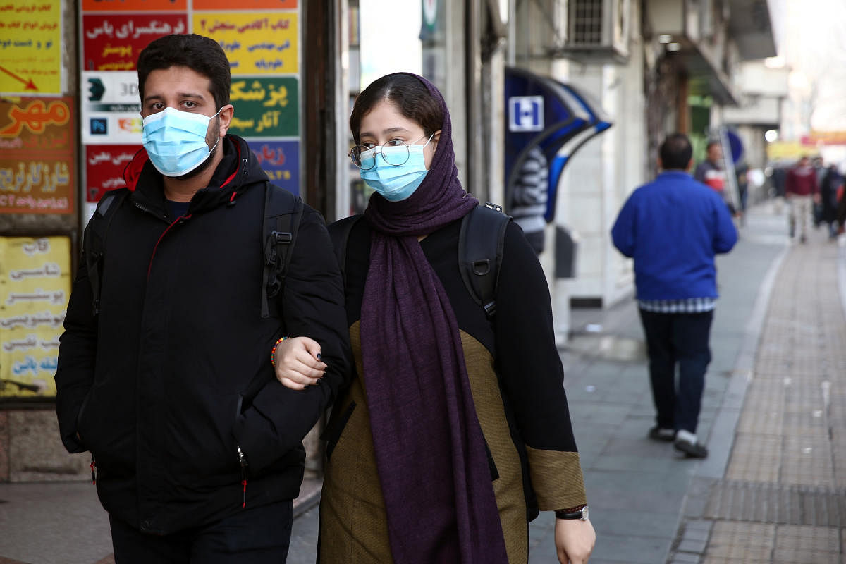An Iranian young couple wear protective masks to prevent contracting a coronavirus, in Tehran, Iran February 29, 2020. Credit: Reuters Photo