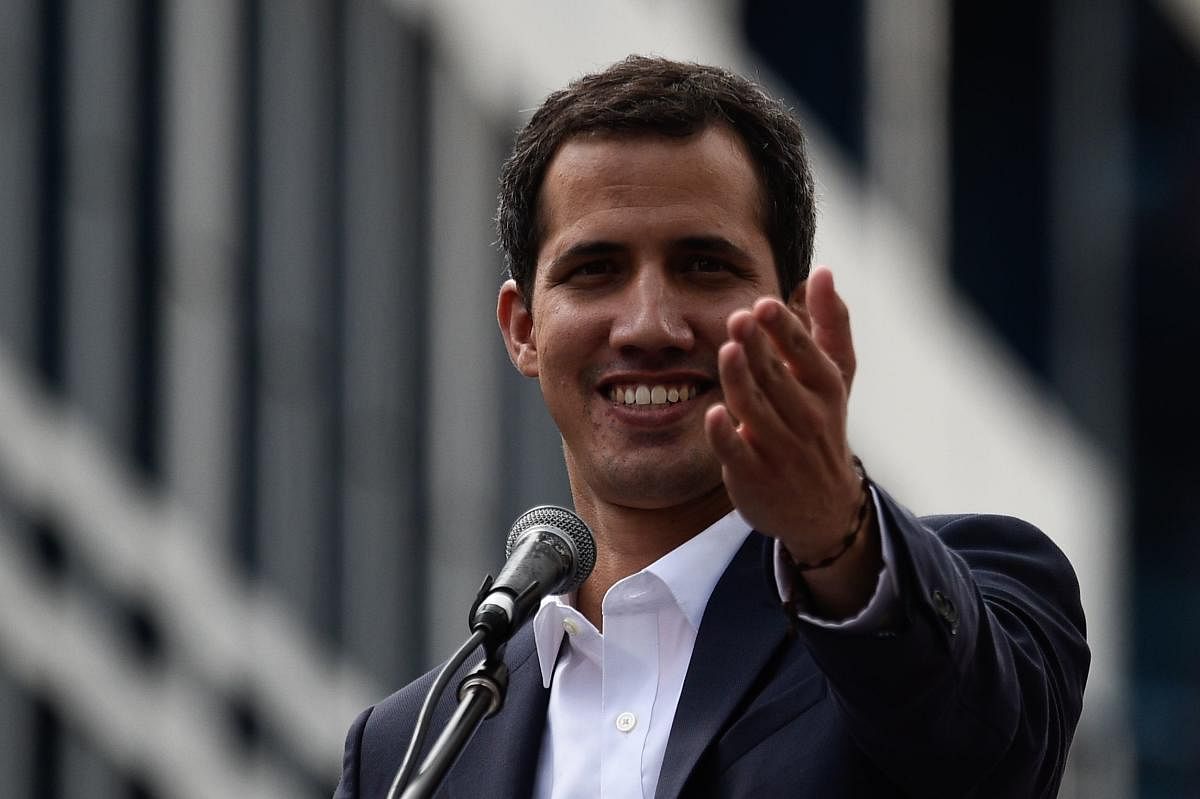 Venezuela's National Assembly head Juan Guaido speaks to the crowd during a mass opposition rally against leader Nicolas Maduro in which he declared himself the country's "acting president", on the anniversary of a 1958 uprising that overthrew a military