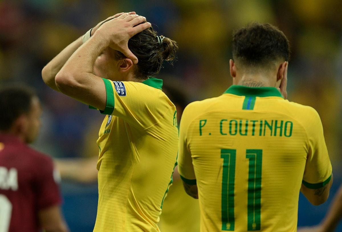 Brazil's Filipe Luis (L) and Philippe Coutinho react during their Copa America football tournament group match against Venezuela at the Fonte Nova Arena in Salvador, Brazil, on June 18, 2019. (AFP)