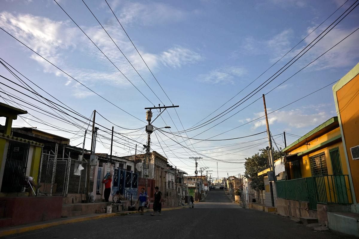 People are seen in a street of Maracaibo, Zulia State, Venezuela as parts in the country, including the capital Caracas, were hit by a massive power cut (AFP Photo)