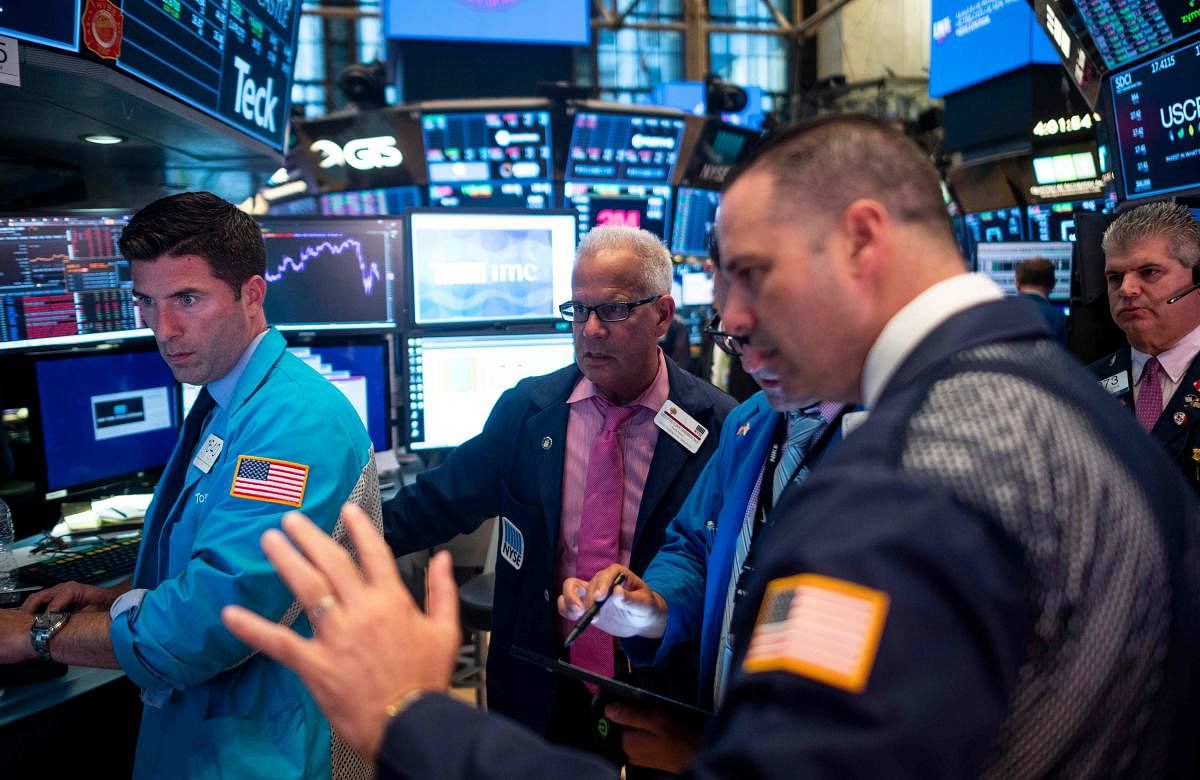 Traders work after the closing bell at the New York Stock Exchange (NYSE) on August 12, 2019 at Wall Street in New York City. - Wall Street stocks finished a bruising session sharply lower as worries about slowing growth and the protracted US-China trade
