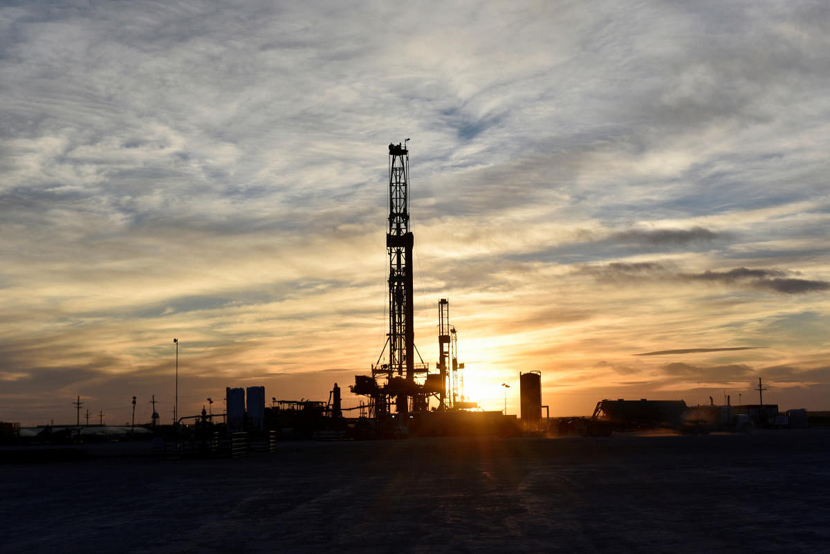 Drilling rigs operate at sunset in Midland, Texas, U.S. (DH Photo)
