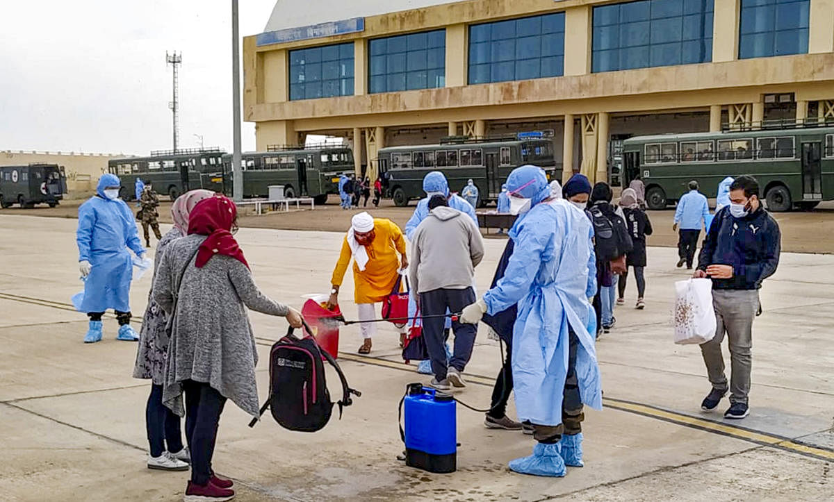 ndian nationals evacuated from Iran undergo a disinfectant process before being quarantined in Indian Army Wellness Facility Centre at Jaisalmer Military Station. Two Air India flights carrying over 230 Indians from coronavirus-hit Iran landed here on Sunday morning. (PTI Photo)