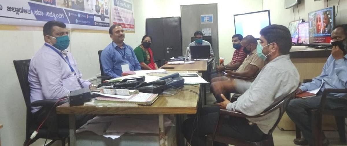 The officials from Social Welfare and ITDP departments participate in the phone-in programme organised by the district administration on Friday. DH Photo