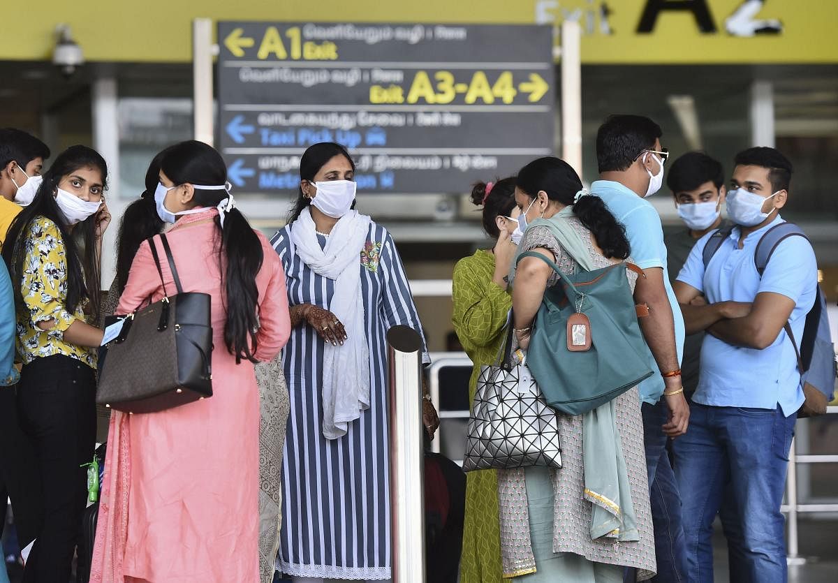  Passengers wear masks to mitigate the coronavirus pandemic at the Chennai airport, Tuesday, March 17, 2020. Credit: PTI Photo