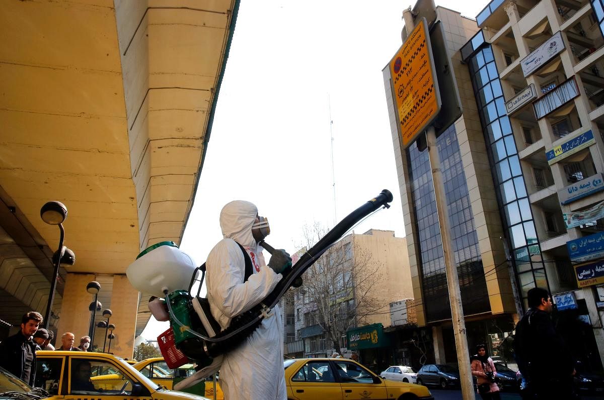 Iranian fire fighters and municipality workers disinfect a street in the capital Tehran for corona virus COVID-19. AFP
