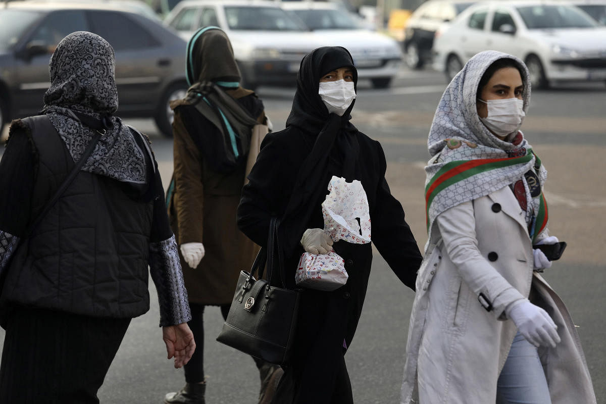 Pedestrians wearing face masks cross a square in western Tehran, Iran, Saturday, Feb. 29, 2020. Credit: AP Photo