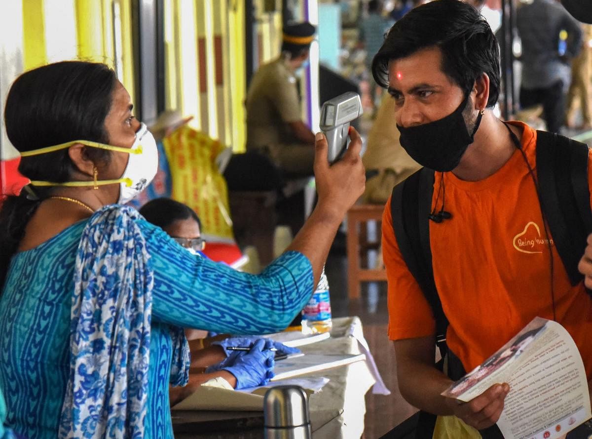 Thermal screening of passengers being conducted in the wake of deadly coronavirus, at a railway station in Kochi, Monday, March 16, 2020. (PTI Photo)