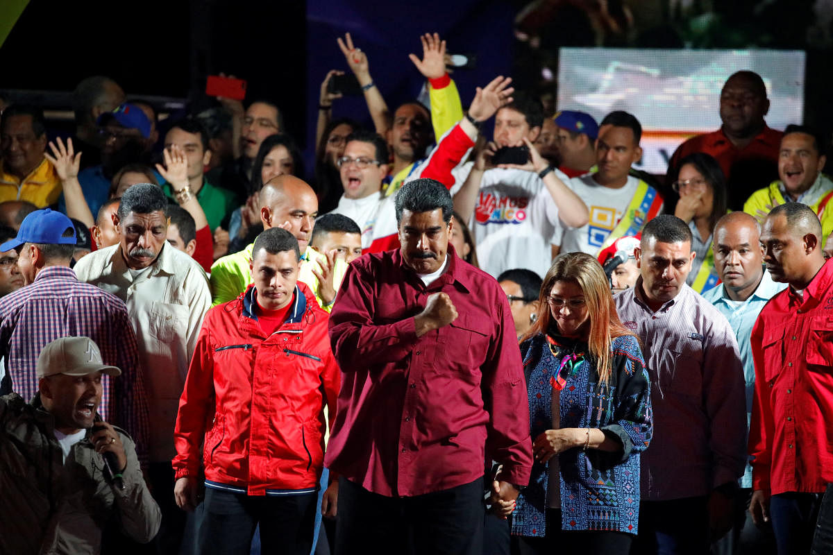 Venezuela's President Nicolas Maduro stands with supporters during a gathering after the results of the election were released, outside of the Miraflores Palace in Caracas, Venezuela, May 20, 2018. Reuters