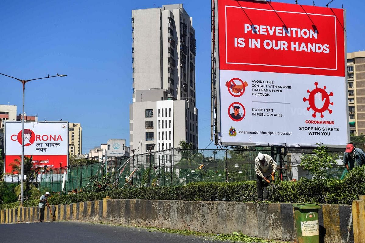A big board displays precautions to prevent the spread of the coronavirus, at a roadside in Mumbai. AFP