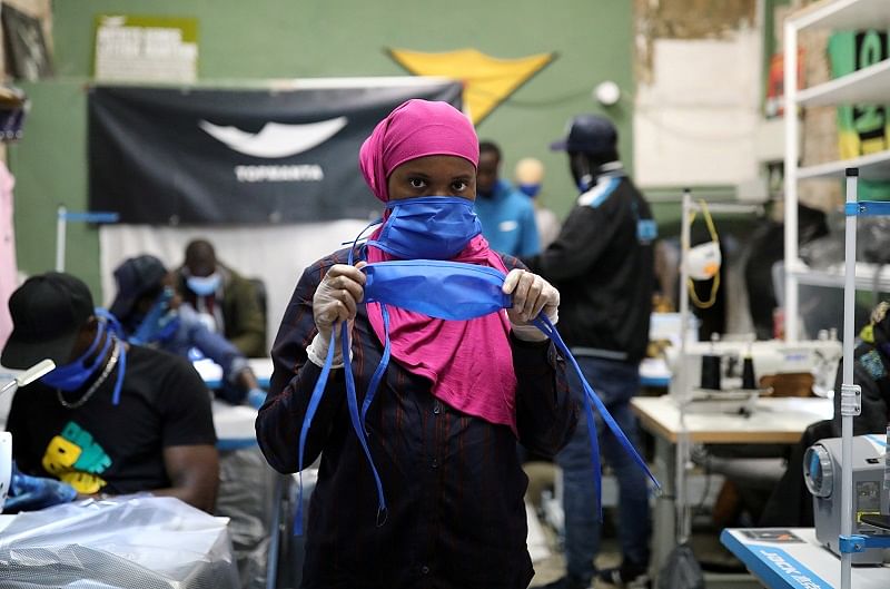 A manteros, member of the Popular Union of Street Vendors and the Top Manta brand, poses in a sewing workshop to produce gowns and masks for Catalan hospitals in the Raval neighbourhood, as the coronavirus disease (COVID-19) outbreak continues, in Barcelona, Spain. (Reuters Photo)