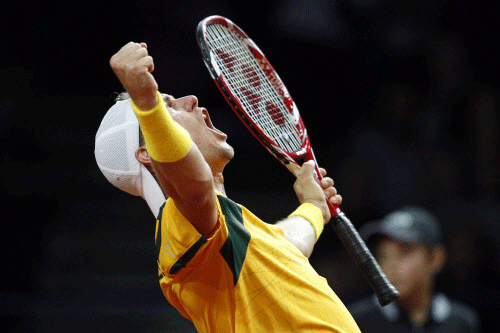 Australia's Lleyton Hewitt celebrates as he wins his Davis Cup tennis match against Poland's Lukasz Kubot in Warsaw September 13, 2013. REUTERS