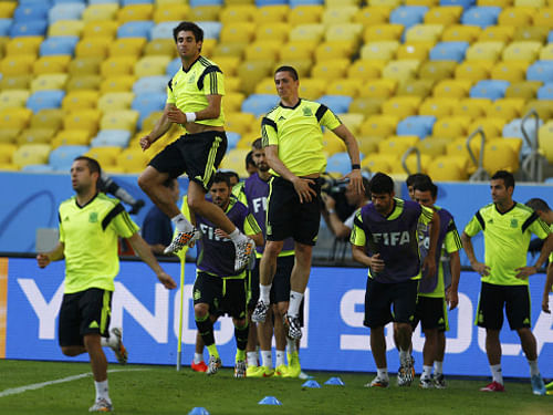 Javi Martinez and Fernando Torres exercise during a training session for the 2014 World Cup at the Maracana stadium in Rio de Janeiro. Reuters photo