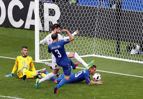 Italy's Giorgio Chiellini, front, scores the opening goal during the Euro 2016 round of 16 soccer match between Italy and Spain, at the Stade de France, in Saint-Denis, north of Paris, Monday, June 27, 2016. AP/ PTI