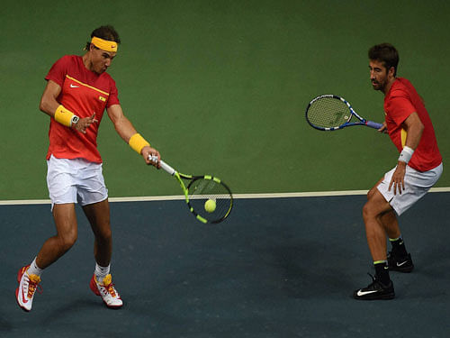 Spain's Rafael Nadal and Marc Lopez in action against India's Leander Paes and Saketh Myeni during the Davis Cup World Group Play off double match , in New Delhi on Saturday.PTI Photo