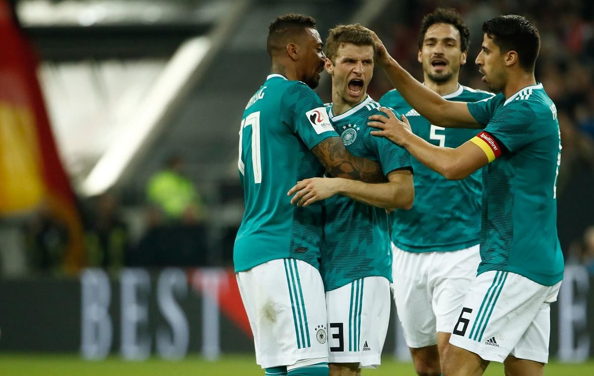 EVER RELIABLE Germany's Thomas Mueller (second from left) is congratulated by team-mates after he scored the equaliser against Spain. AFP